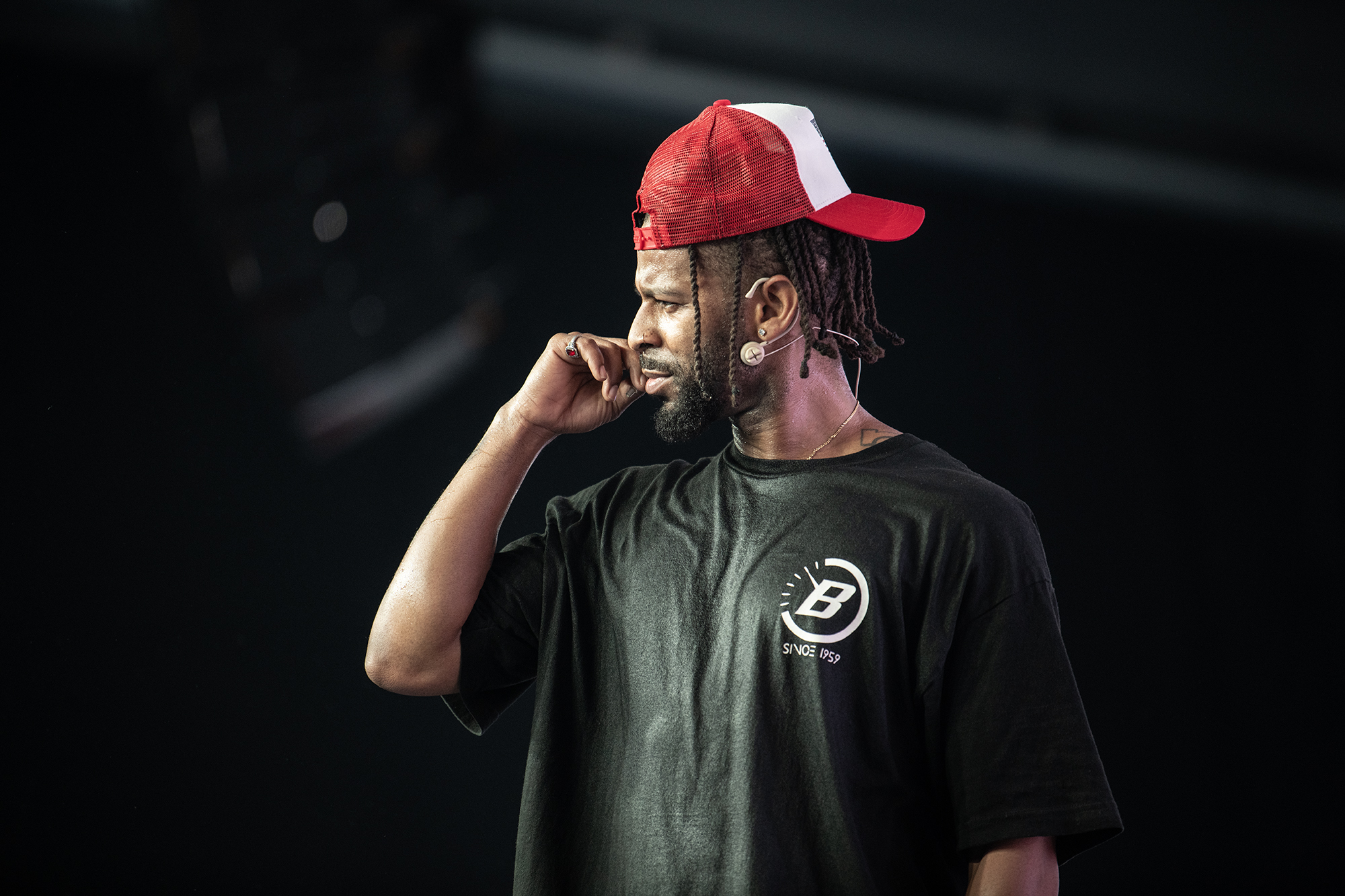 Taiwan Williams in red trucker hat on stage